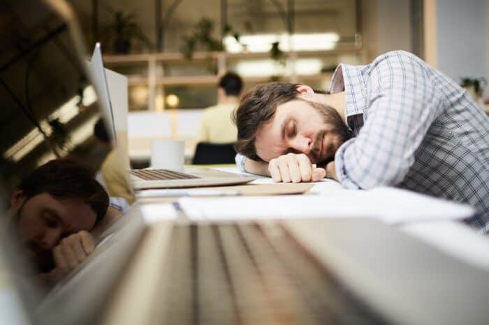 Man sleeping on his desk in front of his computer